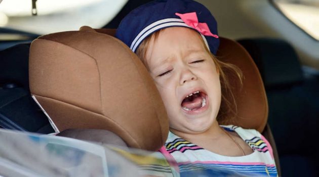 Girl crying in toddler carseat