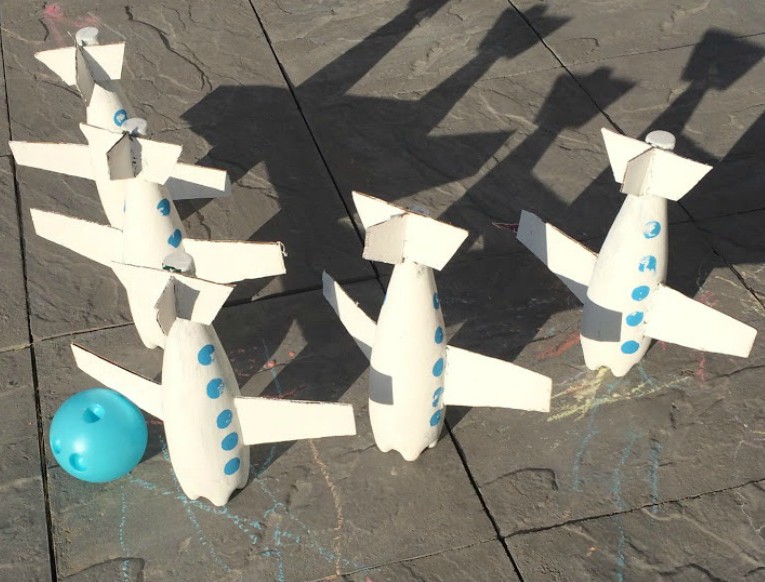 Easy, DIY toddler friendly, airplane bowling craft. PERFECT for an airplane birthday party, indoor play during the winter, or for the backyard during summer time.