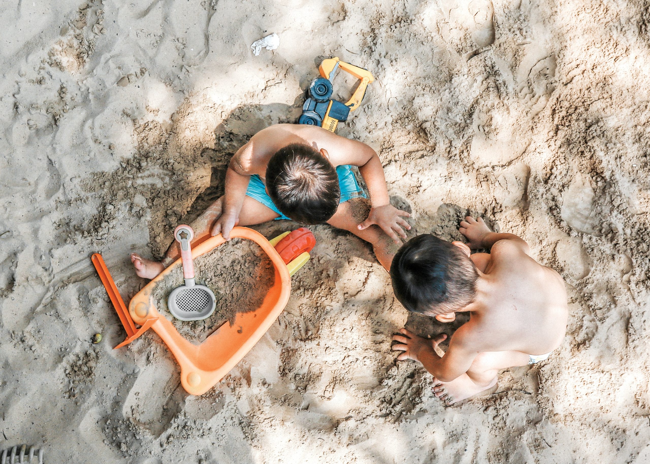 two children playing in the sand together