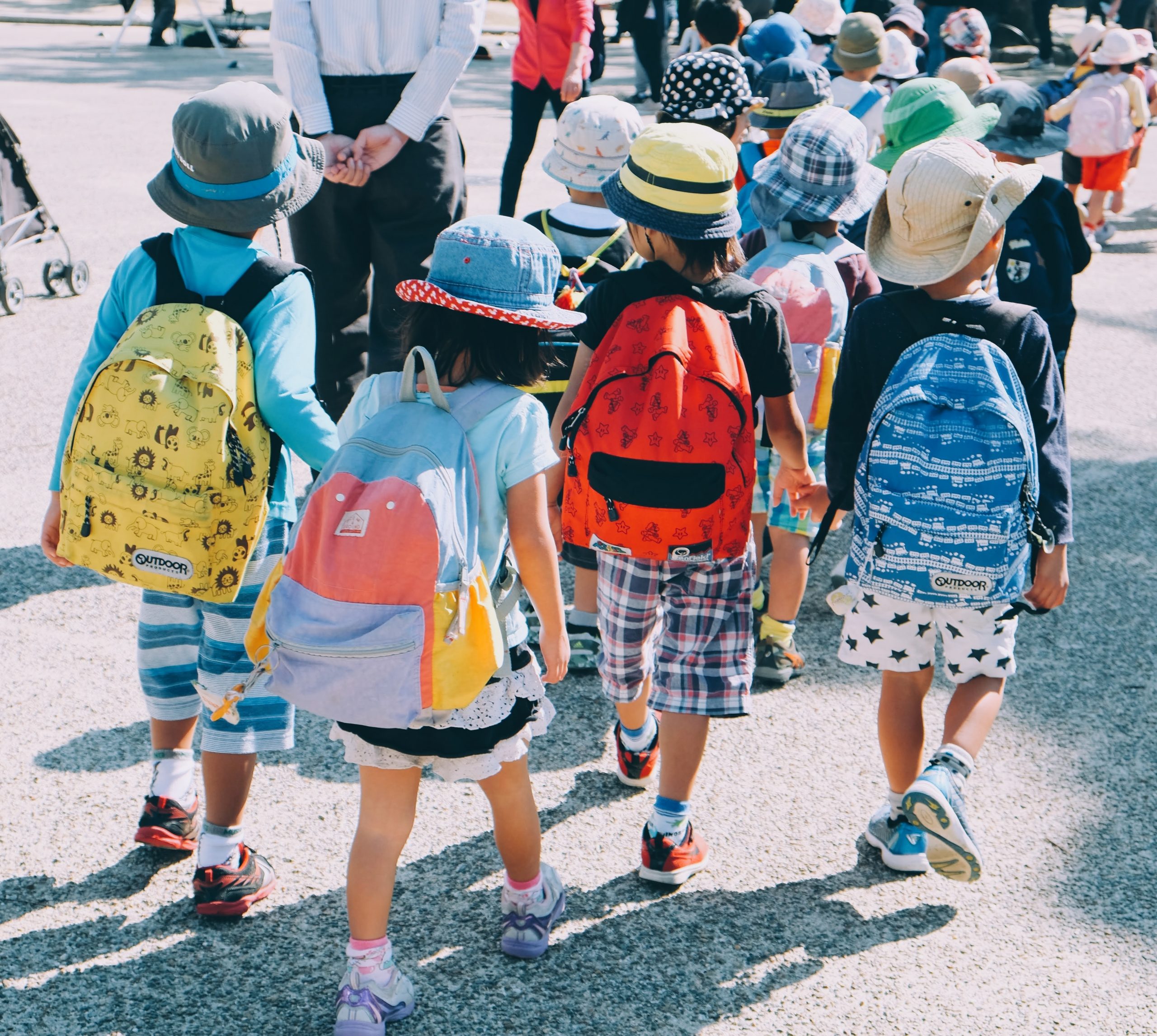 children walking with backpacks after school 