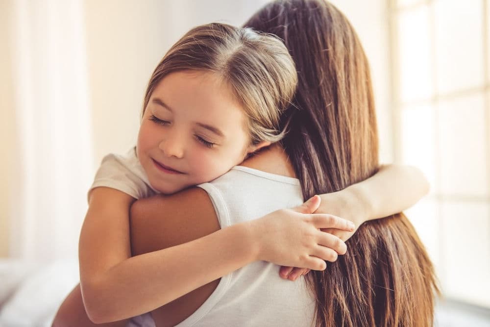 how to execute positive parenting with strength. Mother and daughter hugging