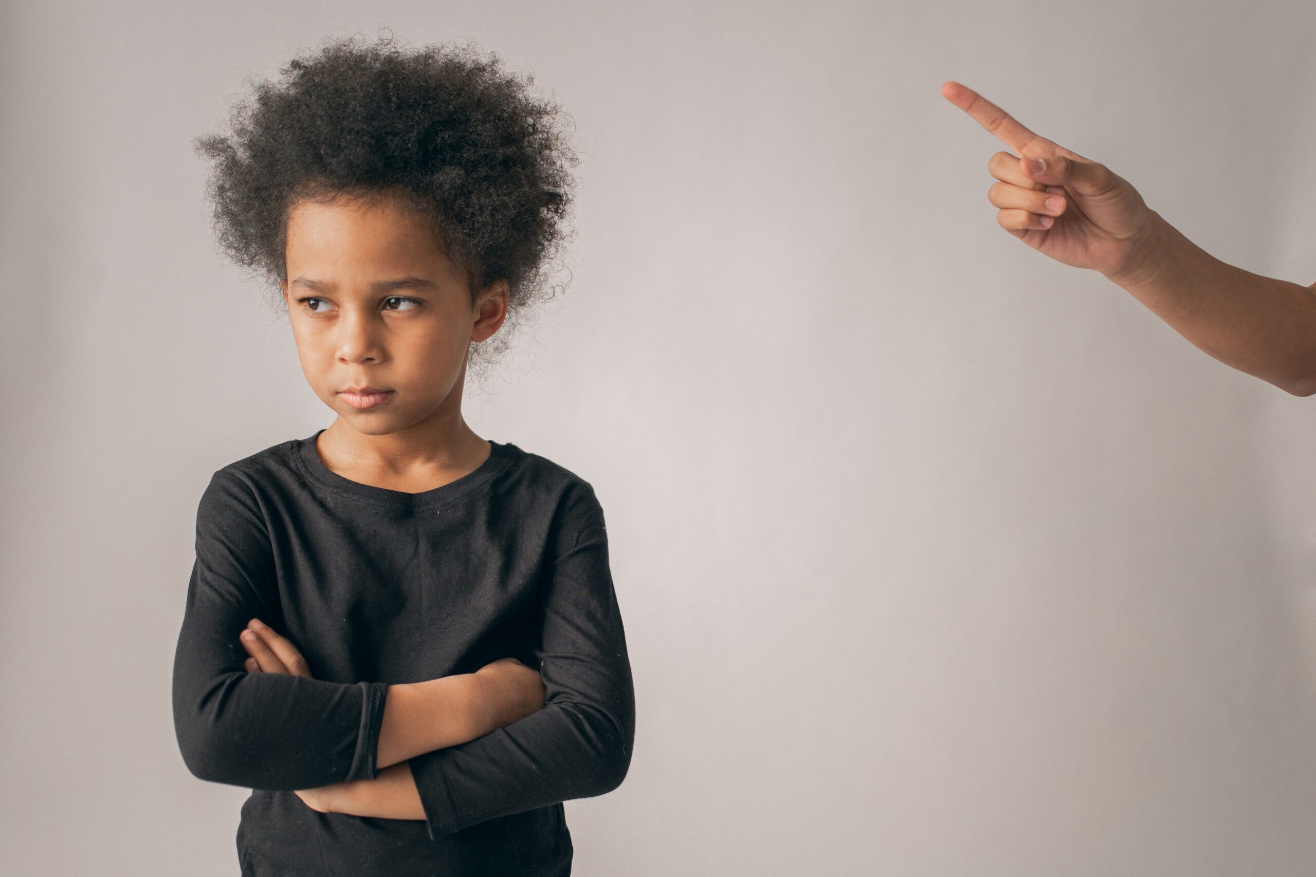 A child who is upset turns away from the parent who is yelling at them.