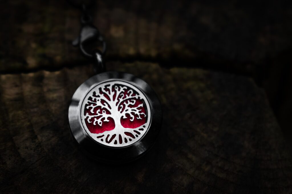 a pendant with a carving of a tree