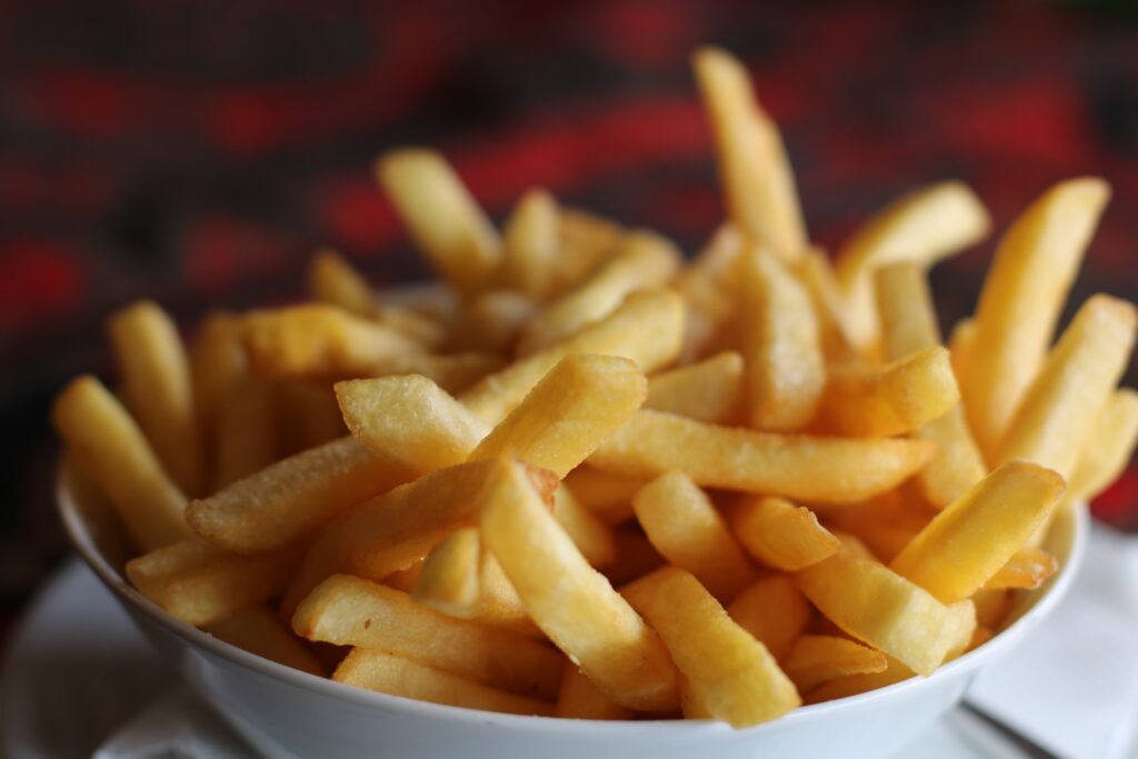 A dish of golden French fries that picky eaters will love.