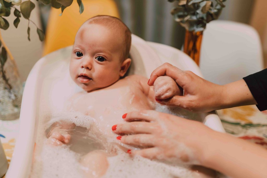 A warm pre-bedtime bath can help ease sleep regression in babies