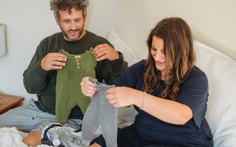 mom and dad preparing clothes for baby