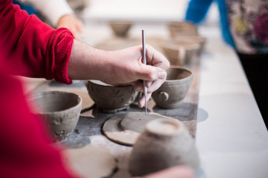 a mom's hand doing pottery