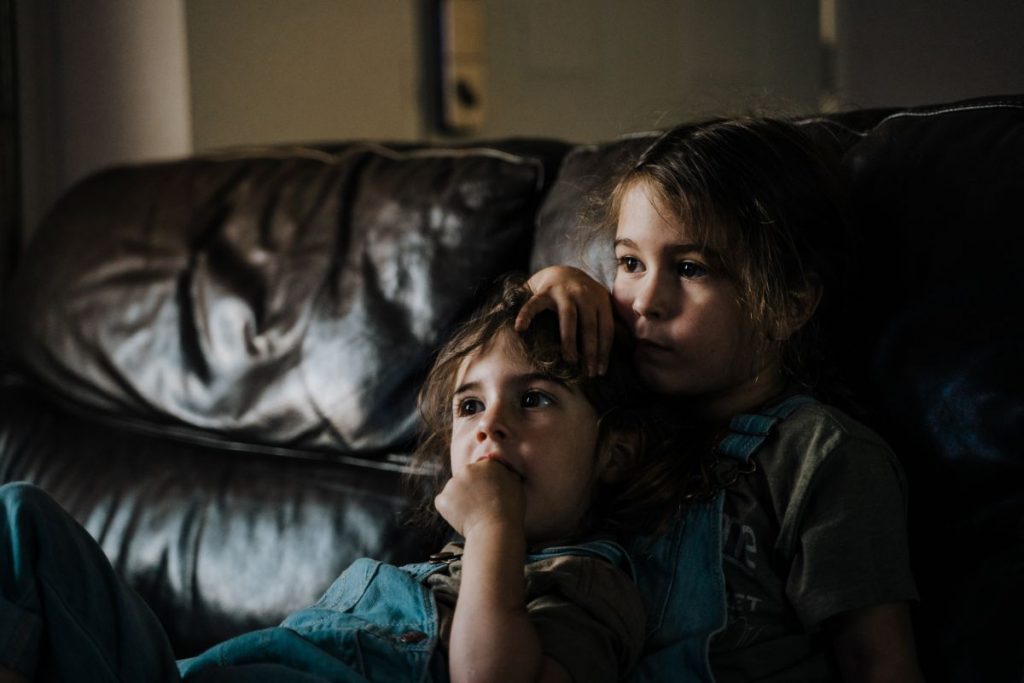 two siblings watching a  movie together