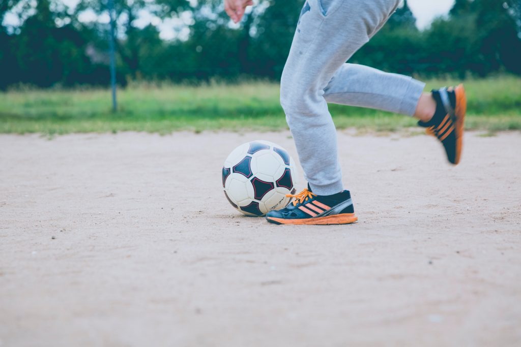 A kid kicks around a football