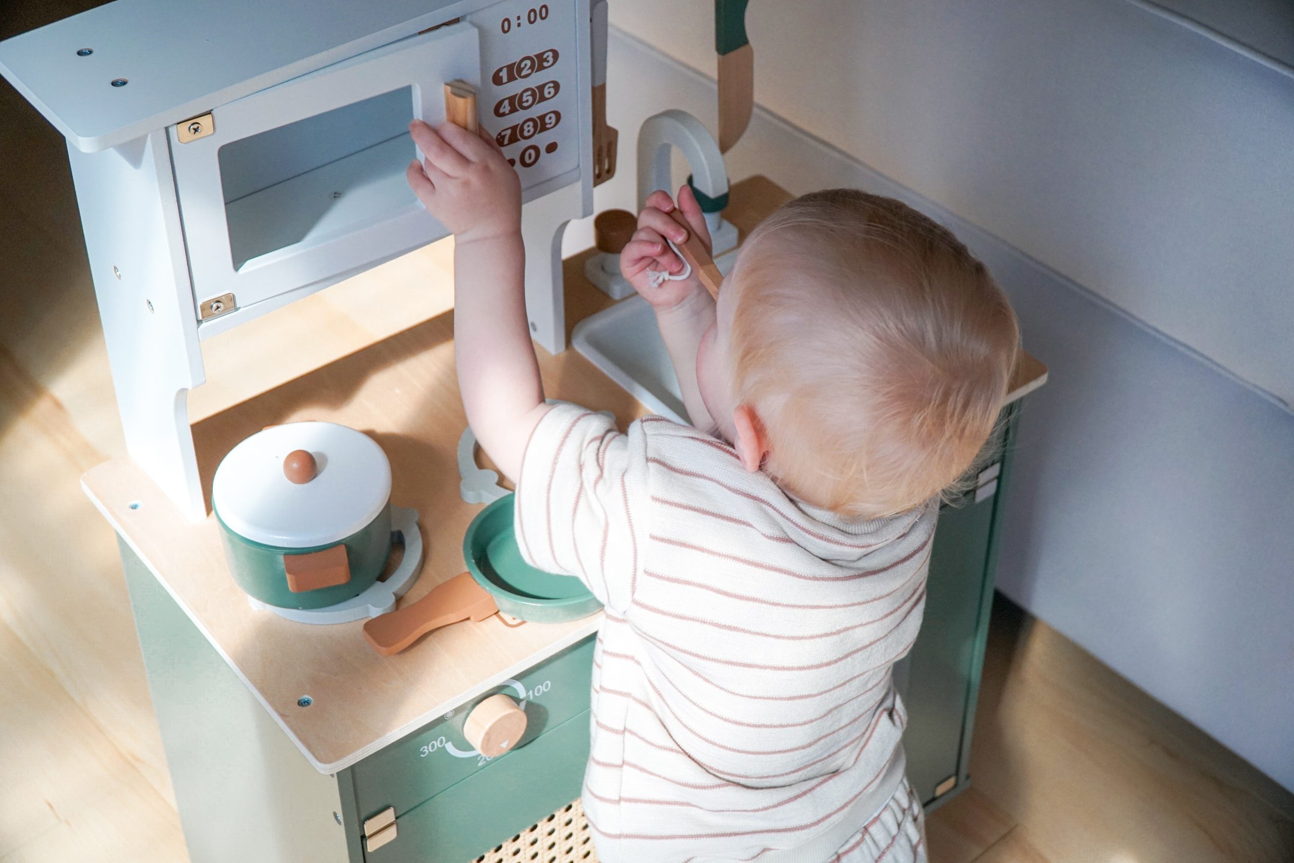 Baby playing with Robud Kitchen play set