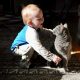 Child playing with a cat