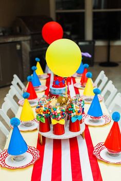 Carnival-themed table set-up for kids showcasing the colors red, blue, yellow, and white.