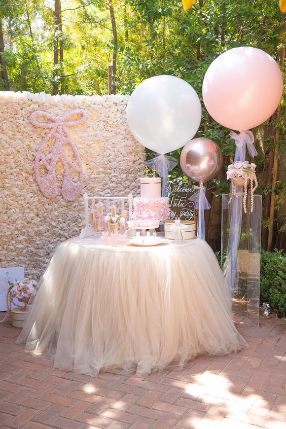Ballerina-theme set up with huge white and pink balloons.