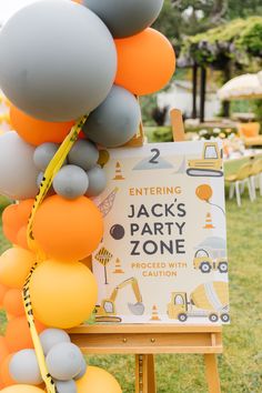 Construction-theme welcome sign with ballons.