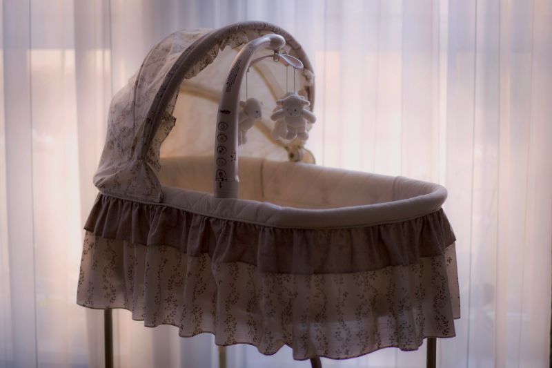 a bassinet with ruffles on the side