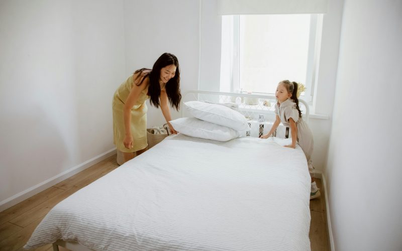 mother and child cleaning a mattress