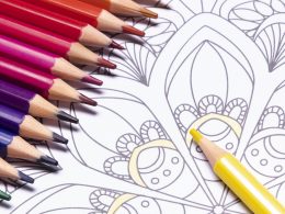 A mandala coloring page and coloring pencils.